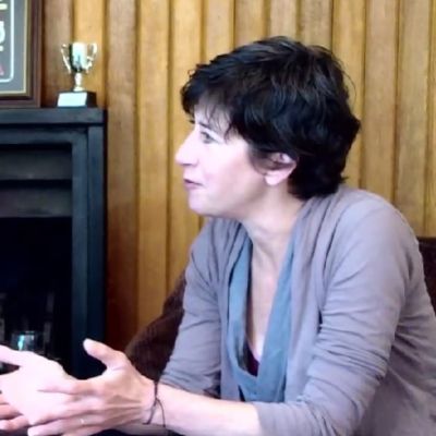 Vanessa Vadim is wearing a purple top in the picture as she is speaking to the host.